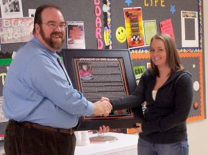 Dean of Students Dr. David McMahan presents the "Student of the Block" plaque to Kristin Wonderley.
