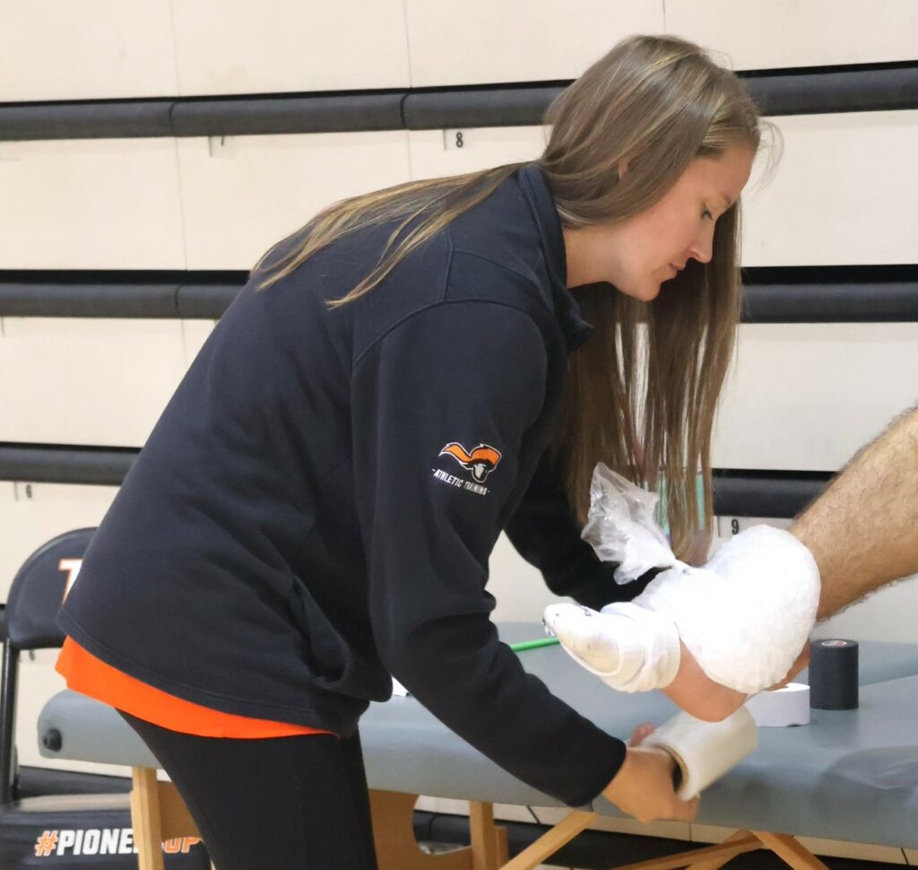 Kaitlyn Diddle treats a player.
