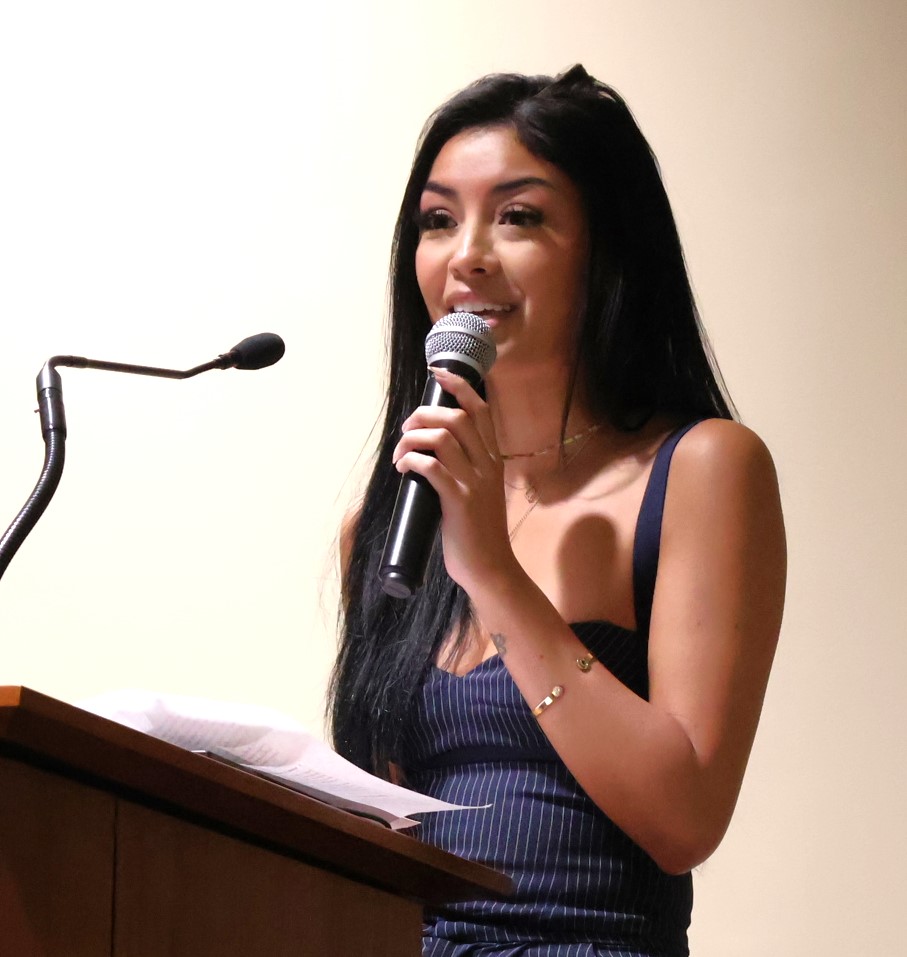 Maria Torres speaks at the debate's onset.