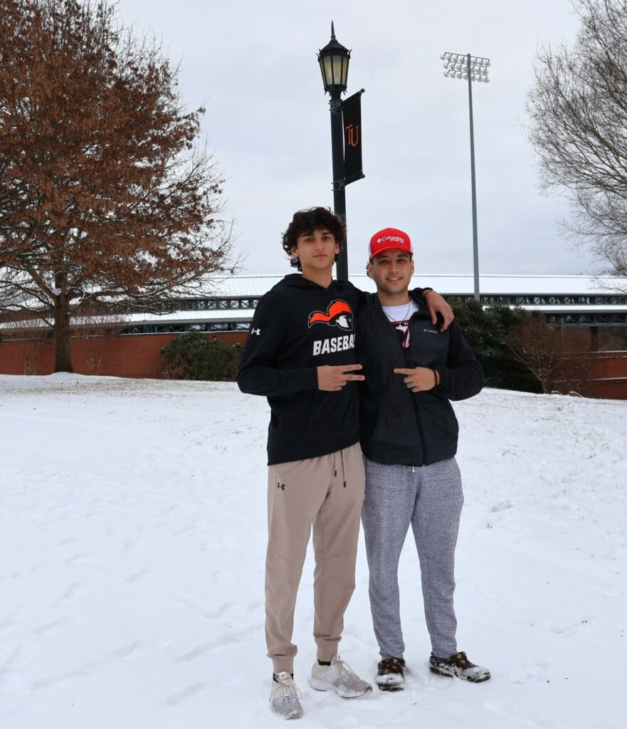 Jake Trottier, left, and Ryan Ortega stand near Pioneer Park in the snow.