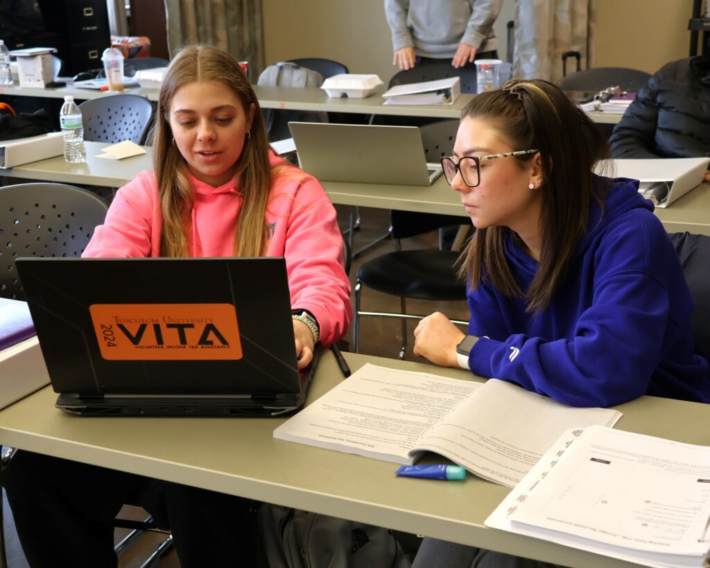 Students participate in training to prepare income tax returns.
