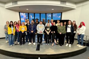 Tusculum students and staff take a photo with Nashville Predators employees.