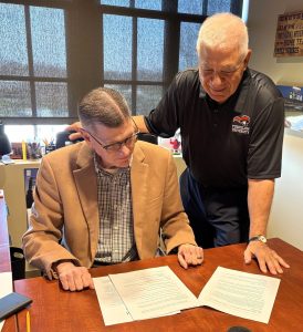 Dr. John Alpers, left, and Dr. Thomas Nuzzi discuss the master's program.