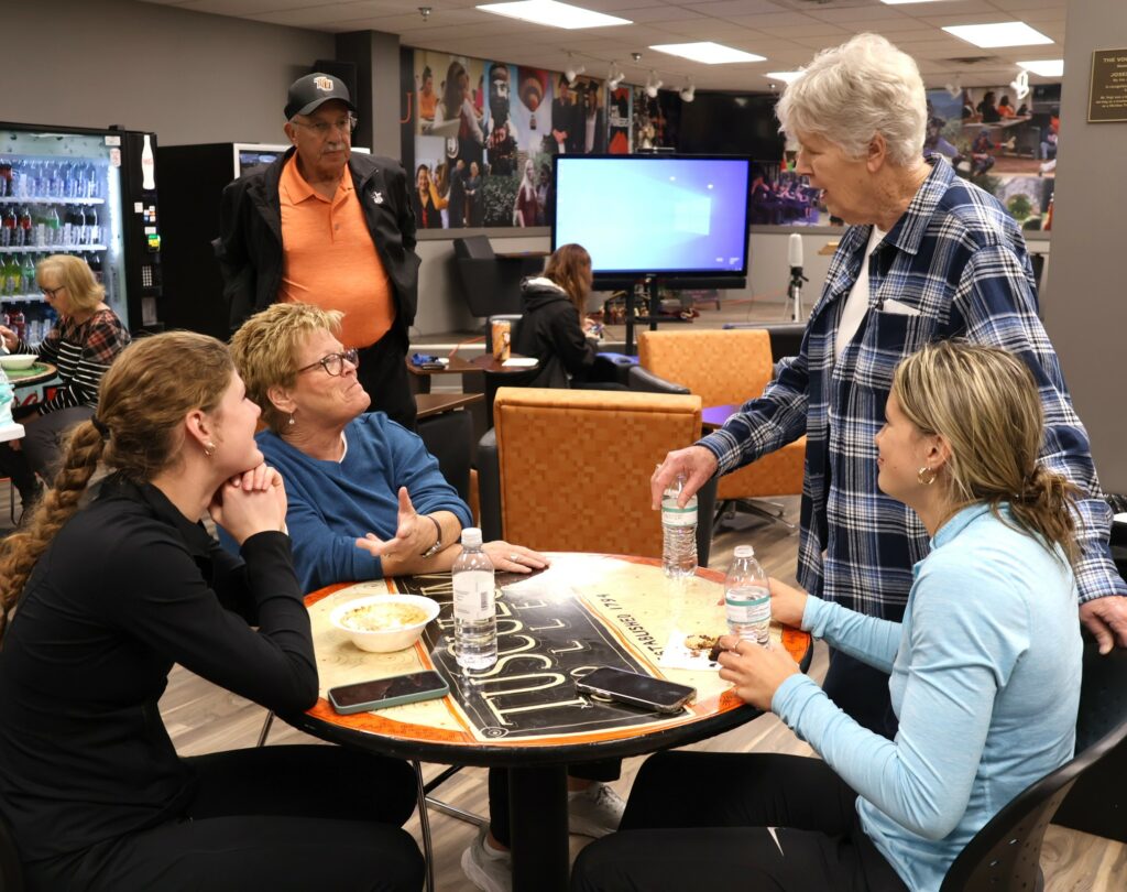 Students and members of First Baptist Church’s Women on Missions mingle during last week's meal.