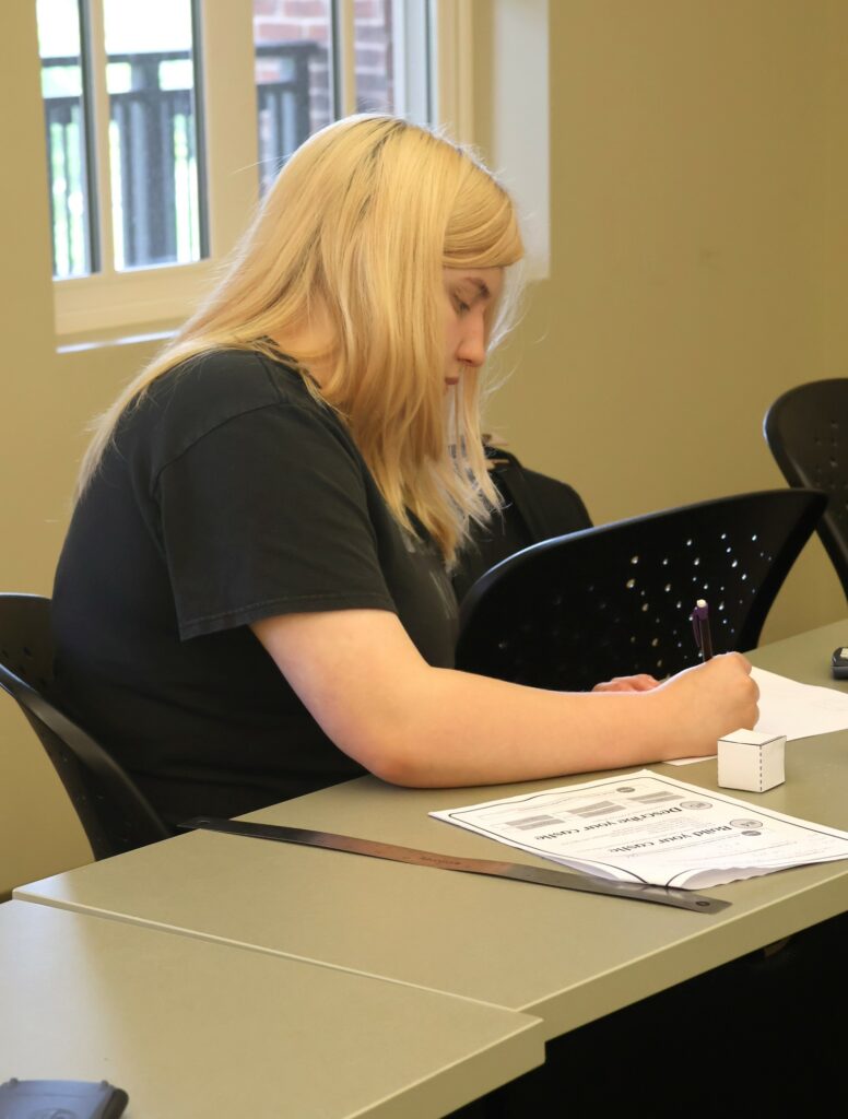 A student completes an assignment in her math class.