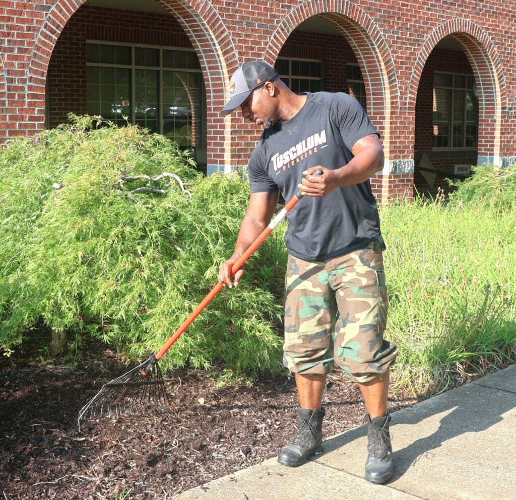 An employee performs landscaping.
