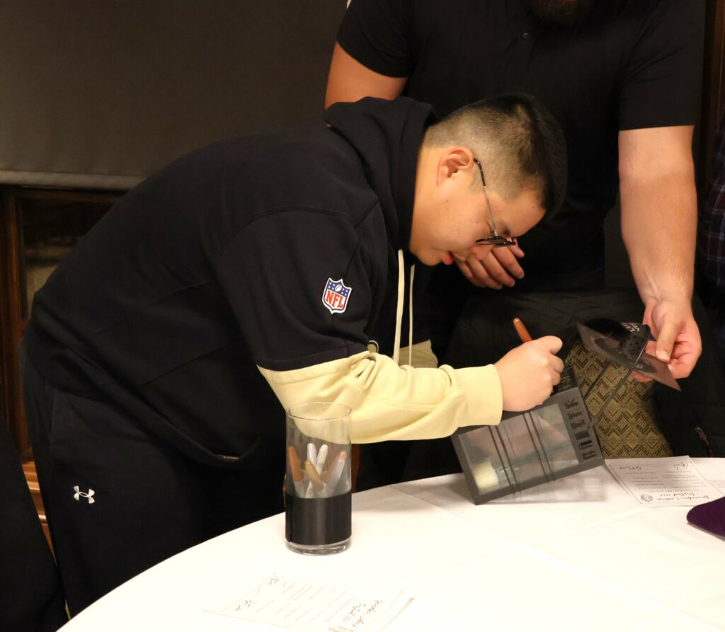 Daniel Wan signs the lantern he gave to Corbin Tomaszewski.