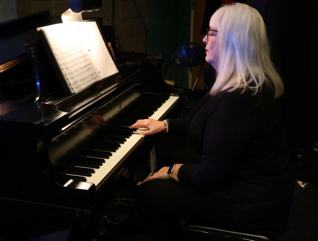 The pianist plays before the concert starts.