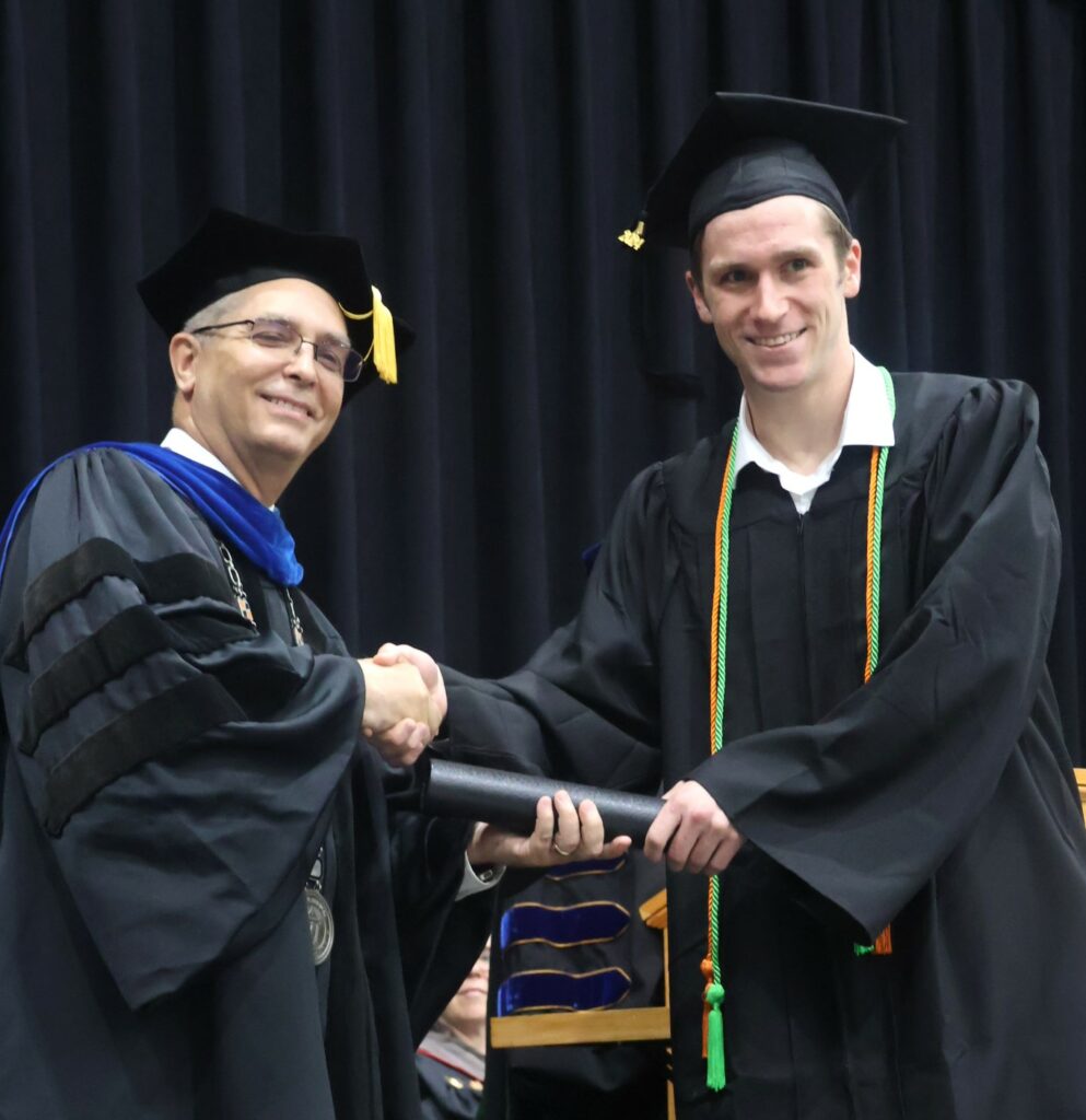 Dr. Hummel, left, congratulates David Bowlin.