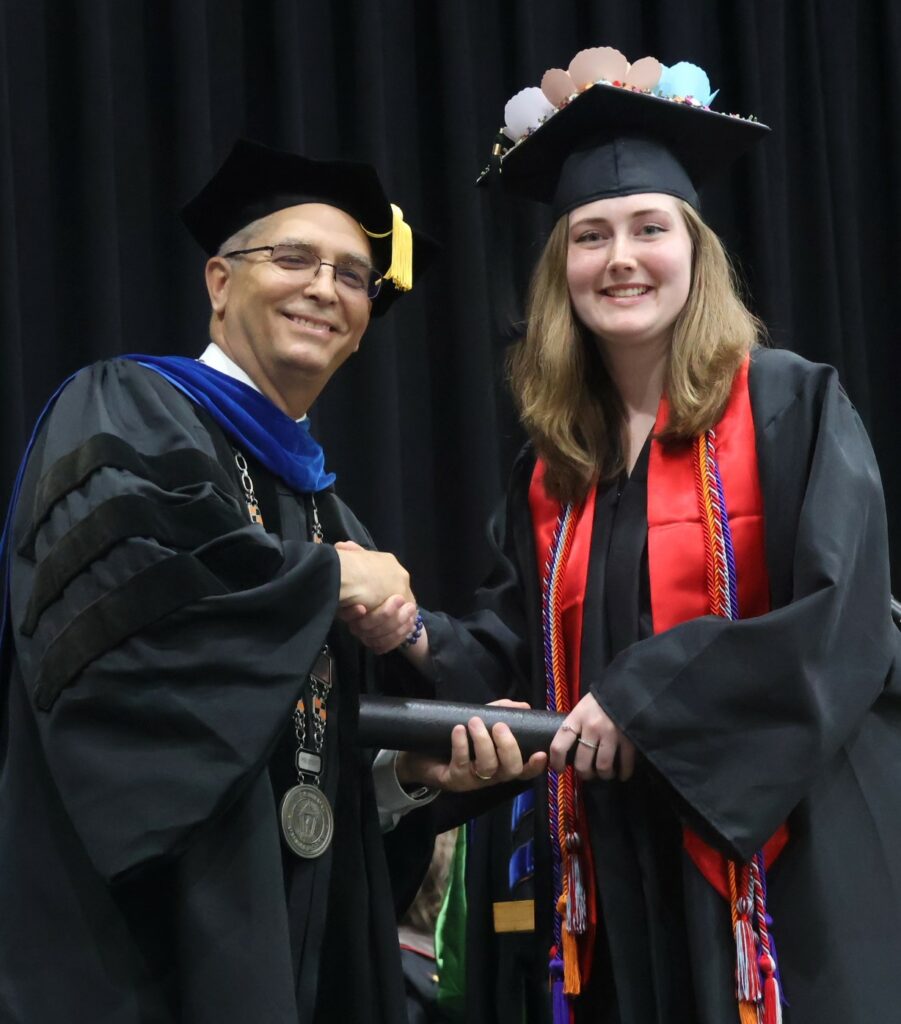 Dr. Hummel, left, congratulates Samantha Nelson.