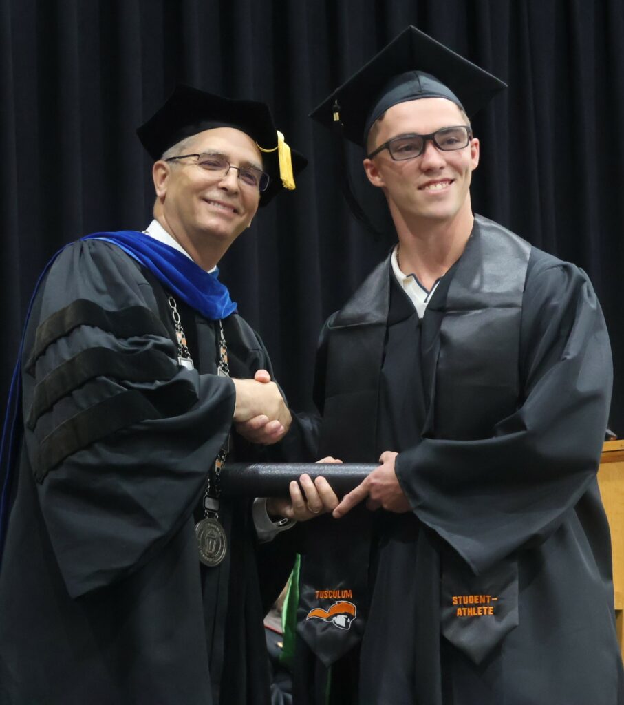 Dr. Hummel, left, congratulates a graduate.
