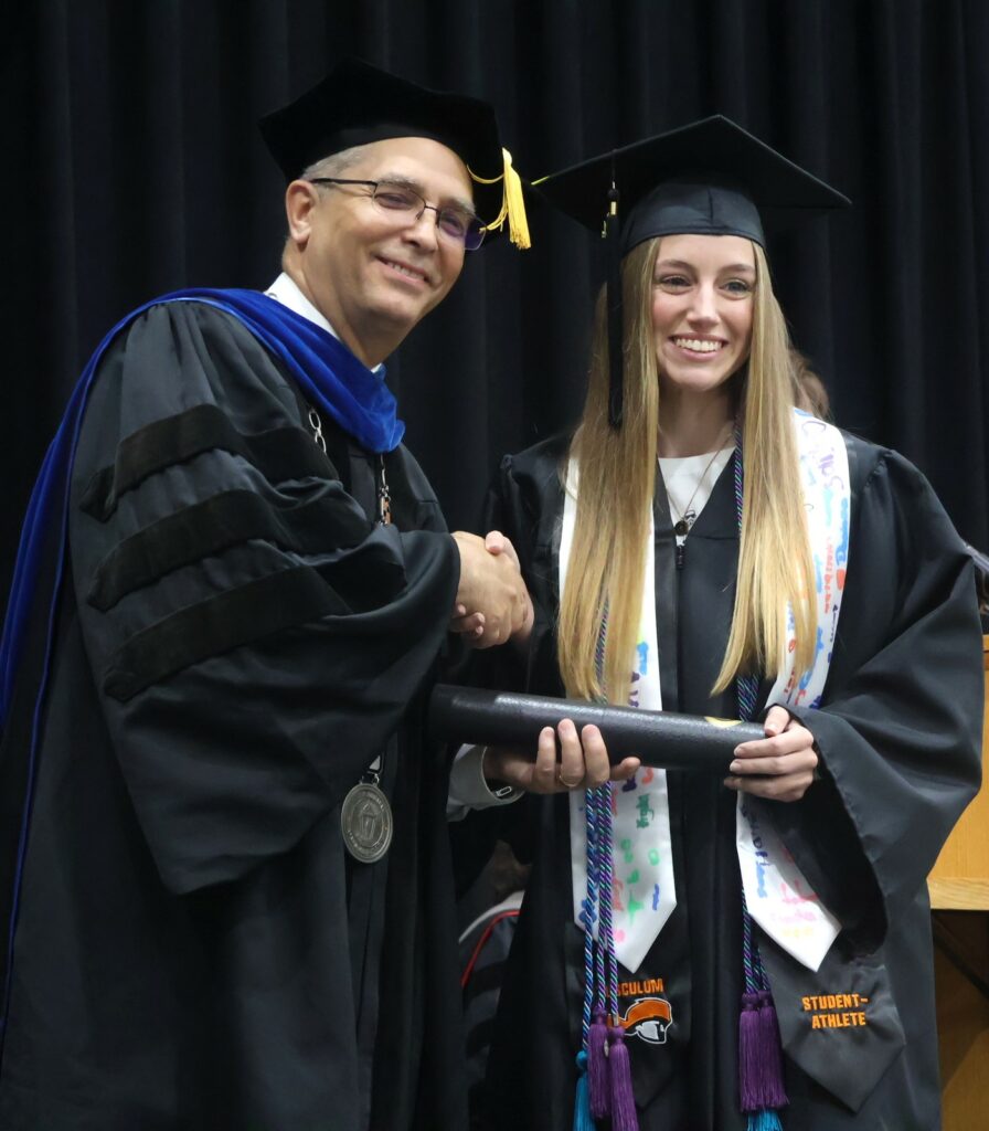 Dr. Hummel, left, congratulates Emily Coddington.