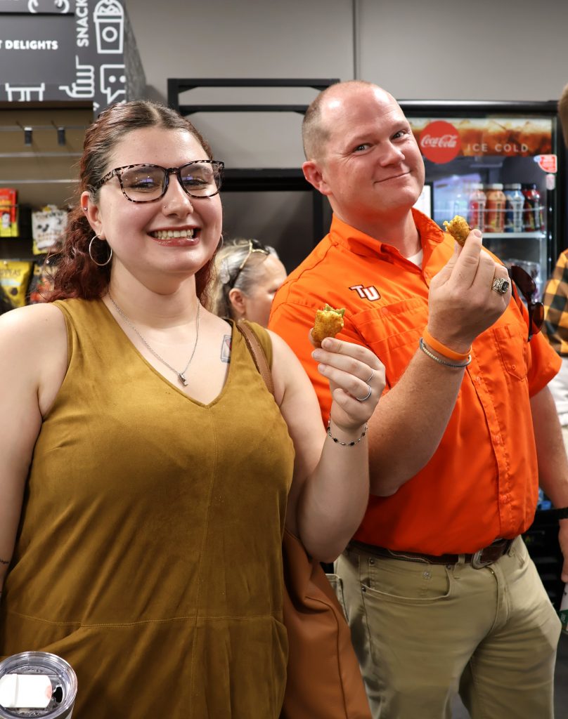Janelle Zirger, left, and the Rev. E.J. Swatsell enjoy some food.