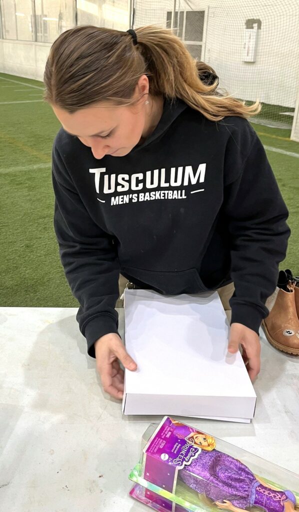 Trinity Velasco prepares to wrap one of her presents.