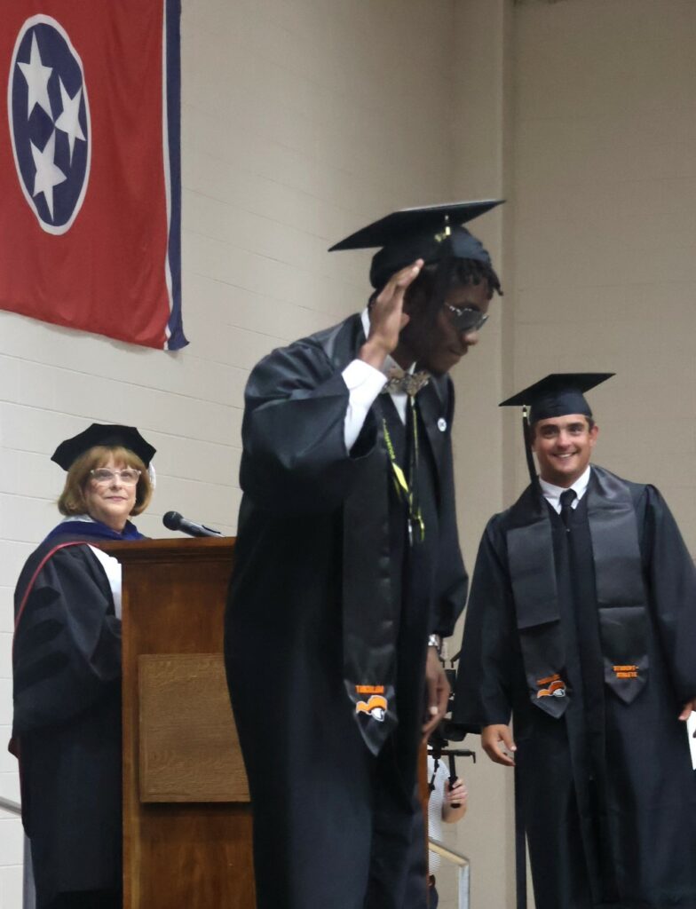 A graduate playfully seeks some noise after his name was announced.
