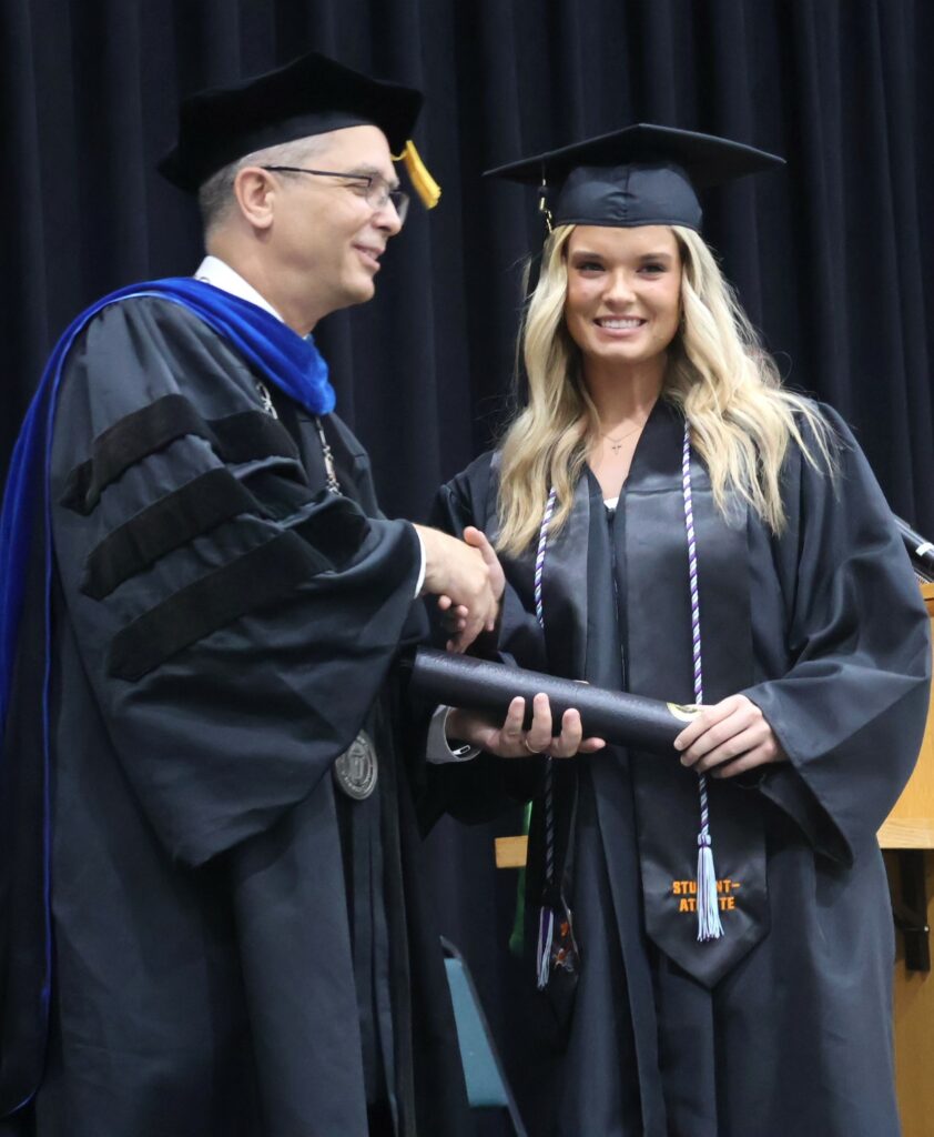 Dr. Hummel, left, congratulates Savannah York.