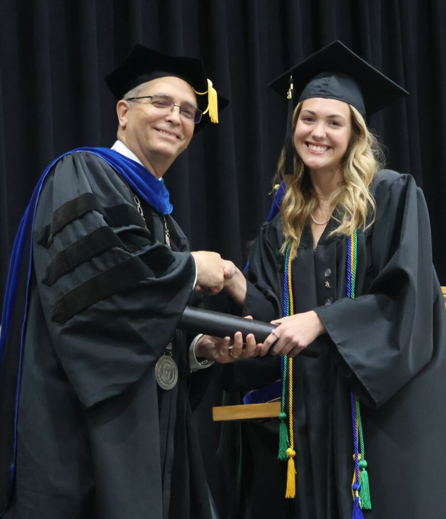Dr. Hummel, left, congratulates Jules Aiken.