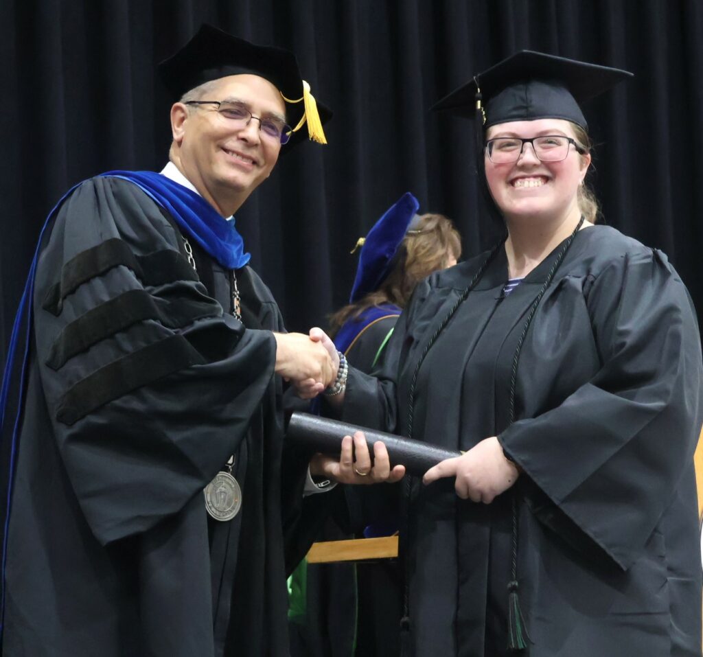 Dr. Hummel, left, congratulates Haley Gibson.