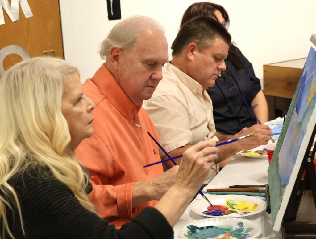 Attendees paint.