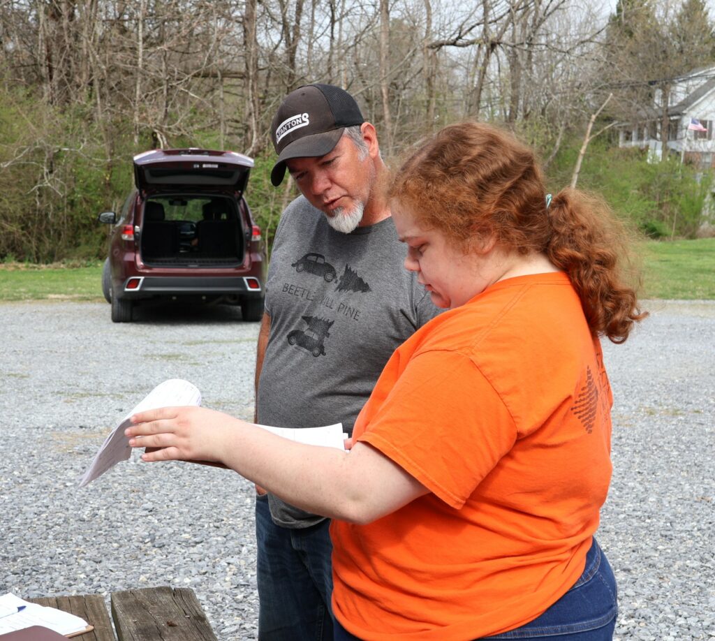 Larry Horn, left, speaks with Zoey Seay about his order.