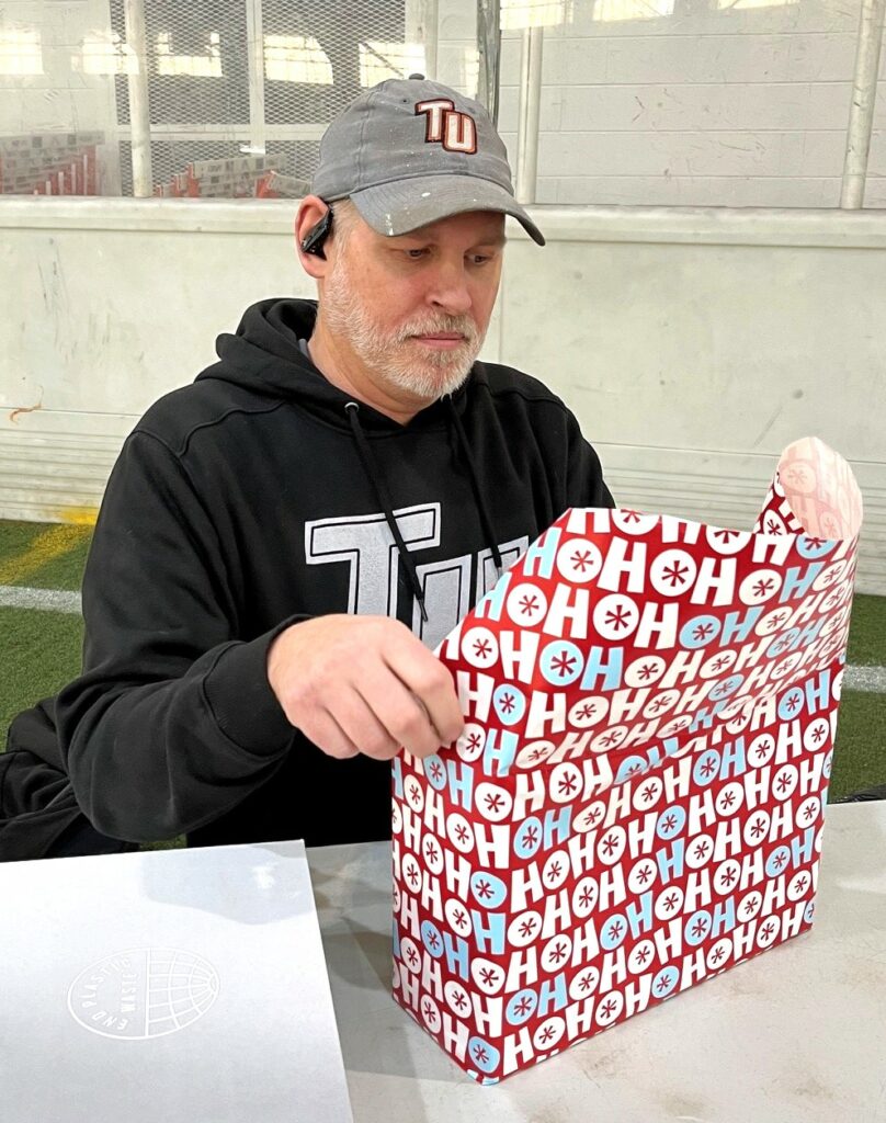 Max Olmsted wraps a gift.