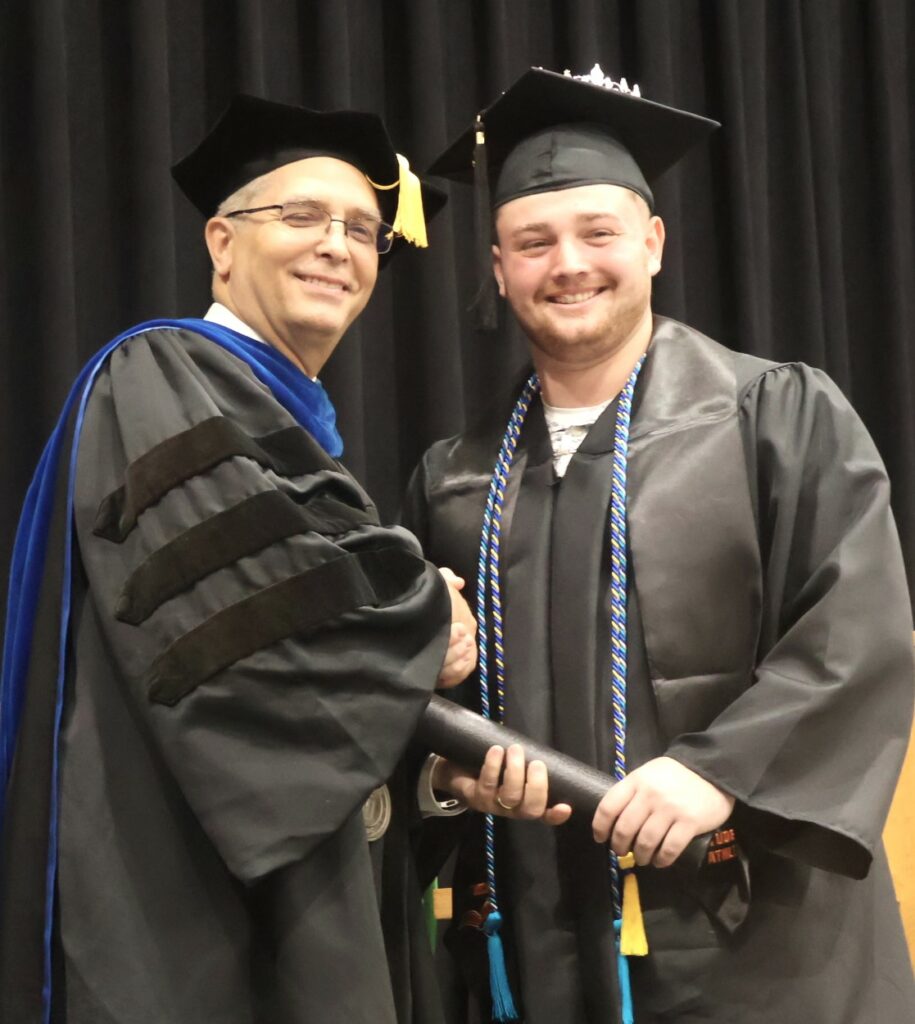 Dr. Hummel, left, congratulates Konrad Sehler.
