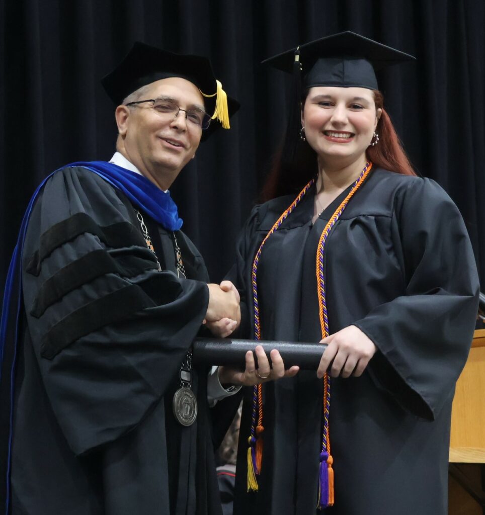 Dr. Hummel, left, congratulates Janelle Zirger.