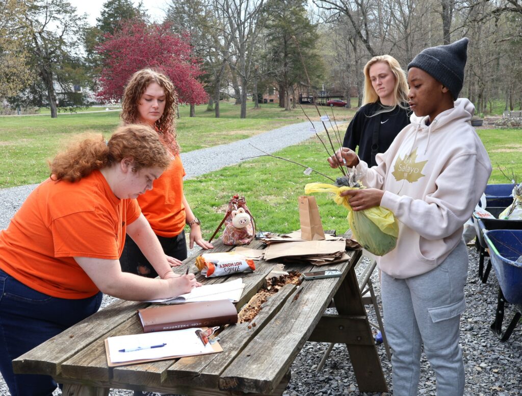 Left to right, students Zoey Seay, Savannah Webb, Alexis Roessler and Zothile Mbhamali process an order.