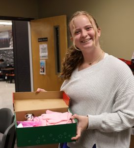 Rylee Durrence shows the contents of one the shoeboxes.