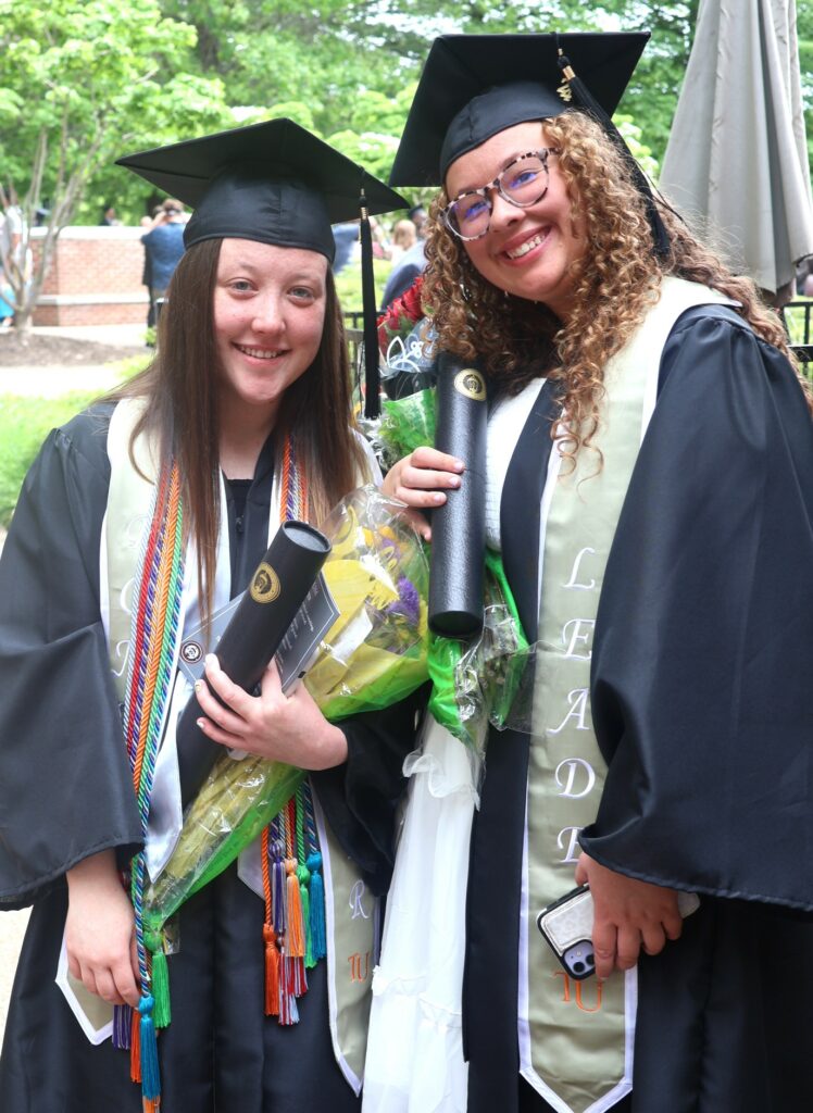 Maggie Vickers, left, and Isabelle Delbridge celebrate after graduation.