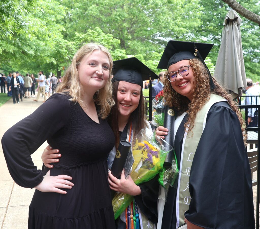 Left to right, alumna Thea Allen, Maggie Vckers and Isabelle Delbridge celebrate after graduation.