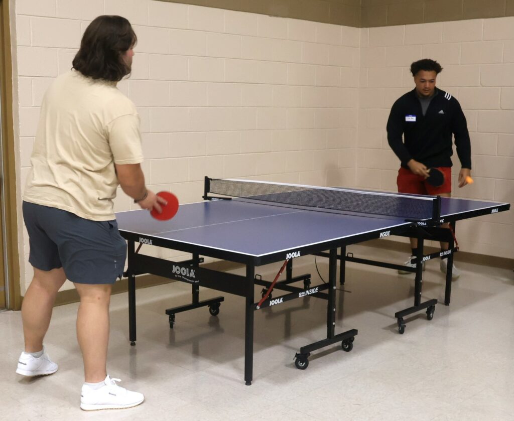 Students play table tennis at the conclusion of SPOT.