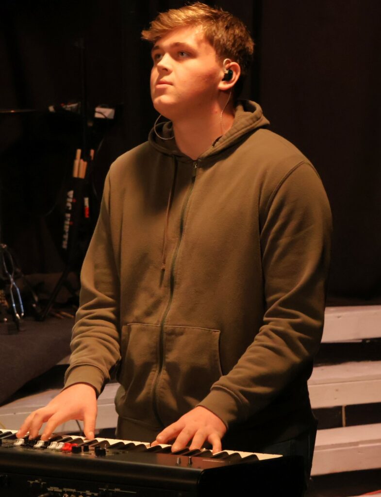 The keyboardist plays.