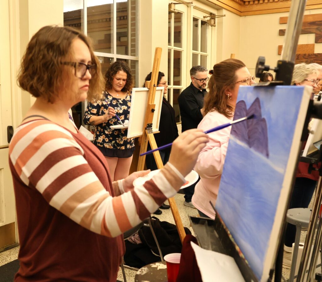 Attendees paint.
