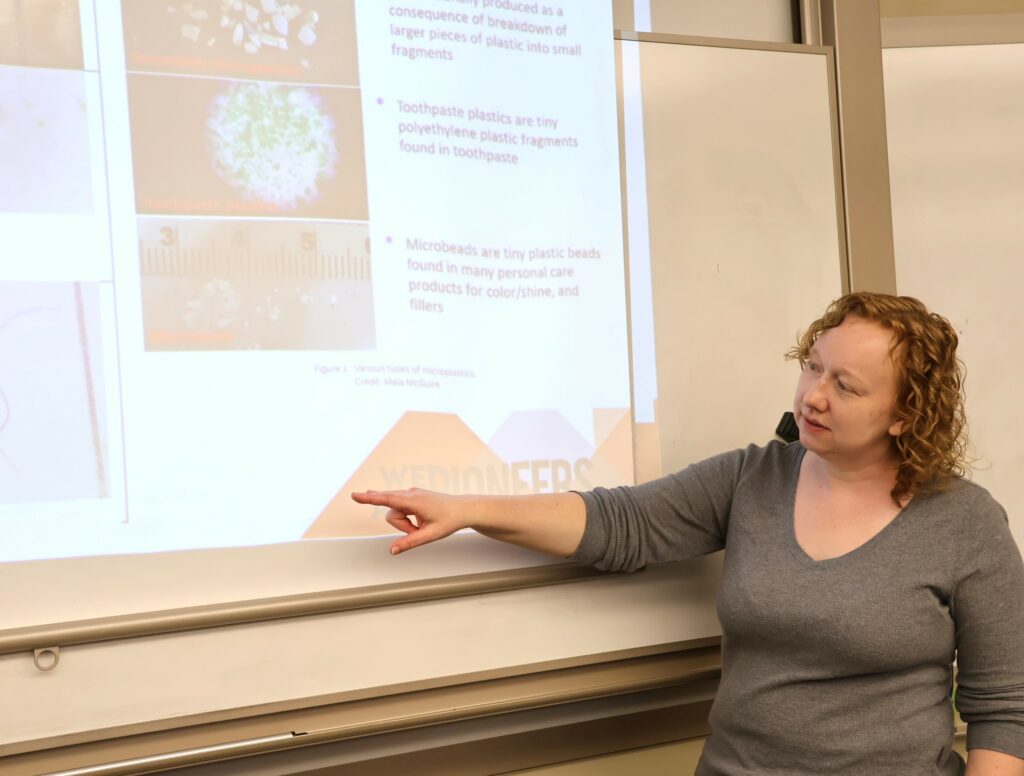 Dr. Kate Smith points to items on the screen.
