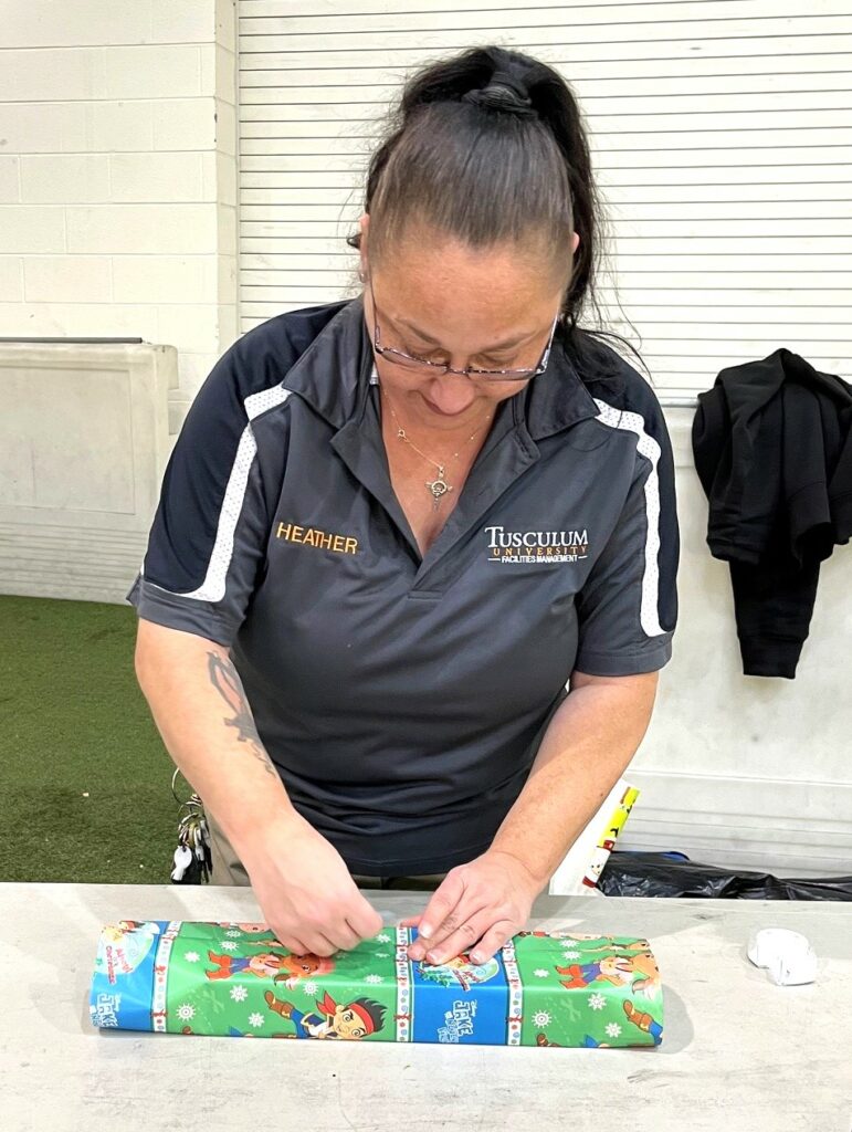 Heather Hensley wraps a gift.