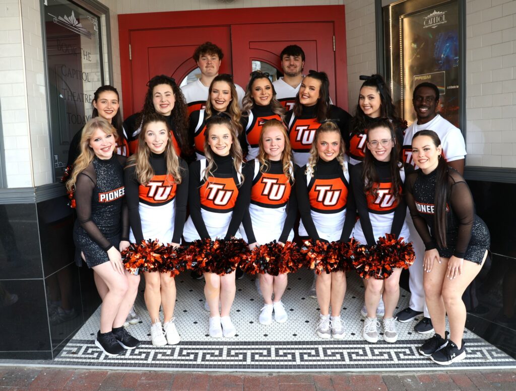 The cheerleading team poses.