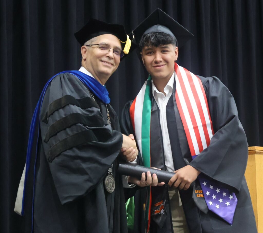 Dr. Hummel, left, congratulates a graduate.