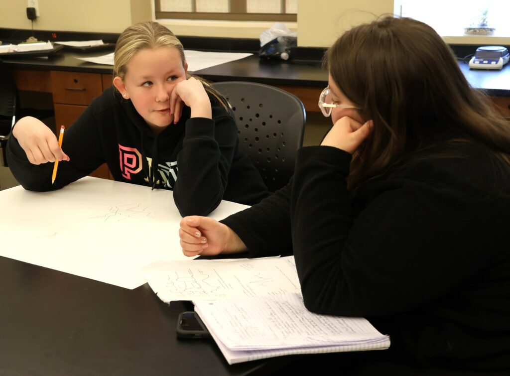 Tusculum student Skylar Lane works with a Girl Scout.