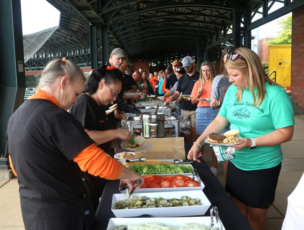 Hungry Pioneers fix their lunch plates.