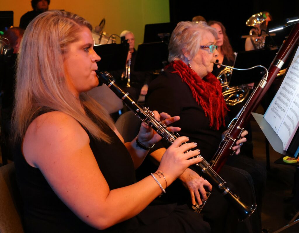 Two band members perform prior to the concert's start.