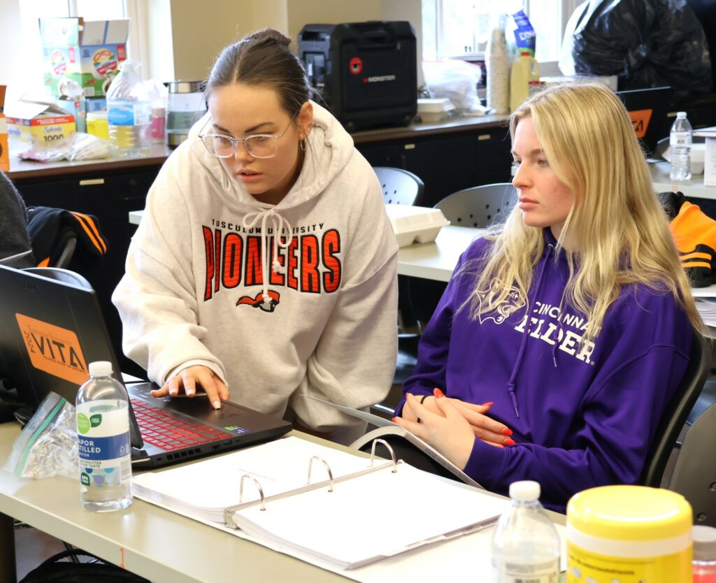 Students participate in training to prepare income tax returns.