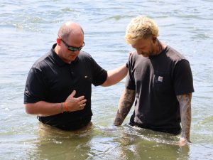 The Rev. E.J. Swatsell, left, speaks with Dare Crusade before the baptism.