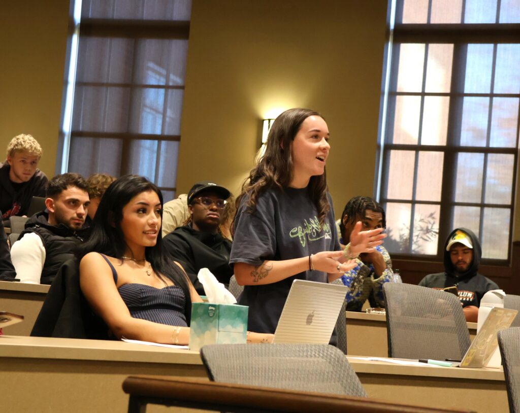 A student asks a question from the audience.