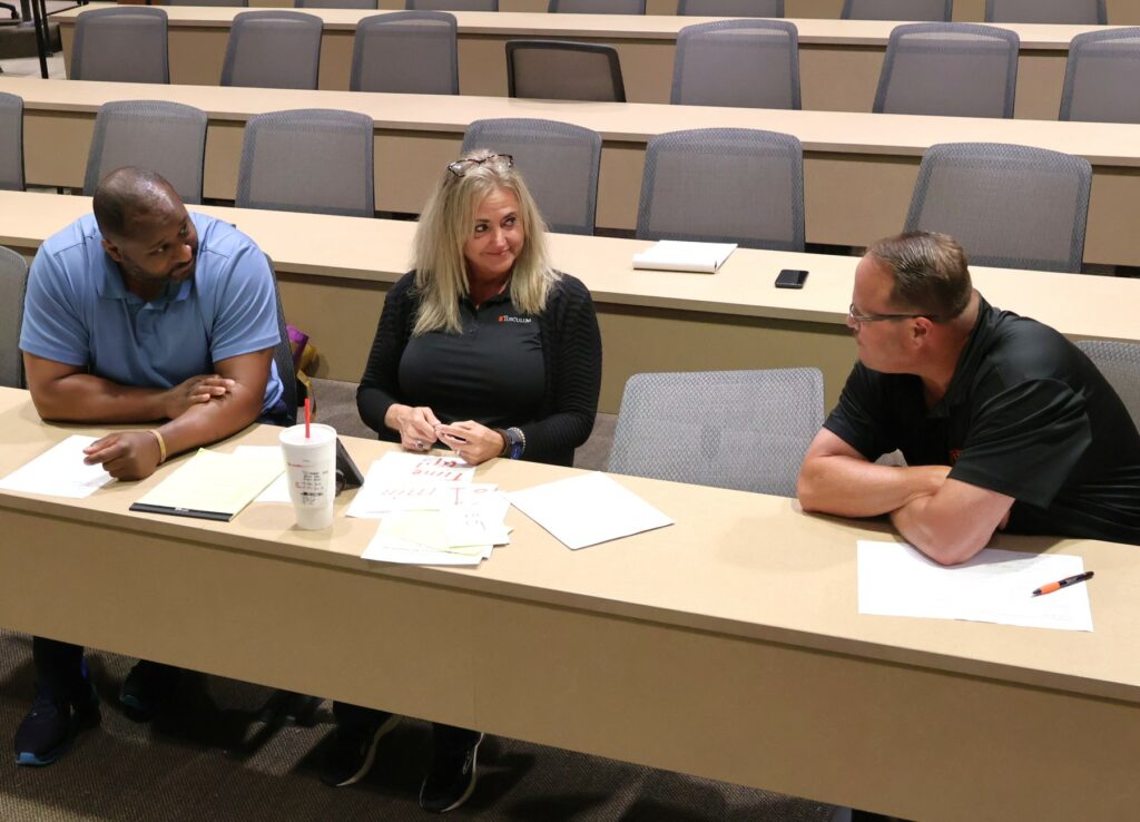 Left to right, Steve Anderson, Lanna Monday, and David Hite speak after the debate concludes.
