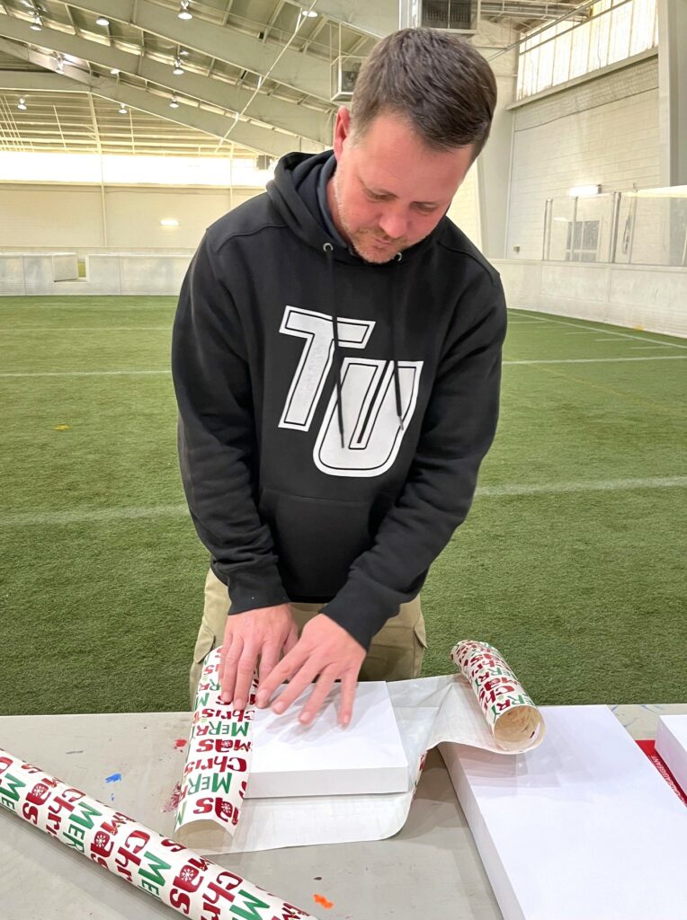TJ Turner wraps a gift.