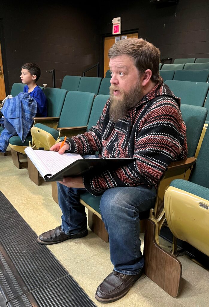 Steve Schultz, the director, watches the auditions.