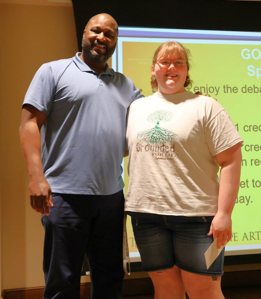 Steve Anderson, left, stands with Jaida Ellison, who was chosen as the best speaker on the winning side.