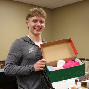 Luke Smith shows a box he packed.