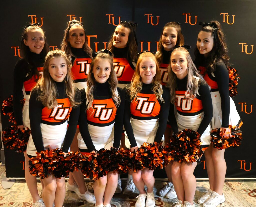 The cheerleading team poses.